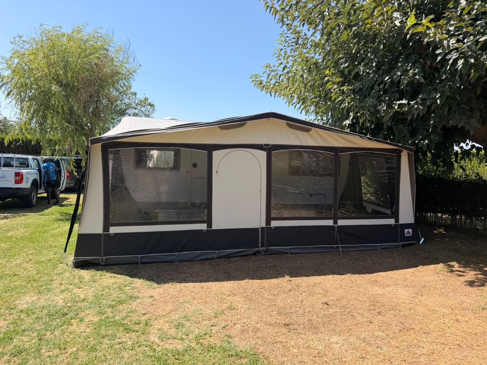 Caravan with a full-width awning on a grassy pitch